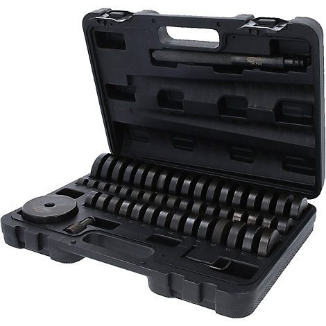 Schwarzer Werkzeugkoffer mit verschiedenen runden Werkzeugen und einem Stift.