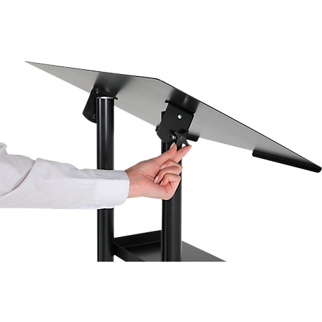 A person adjusts a black lectern table. The table has a slanted, adjustable writing surface.