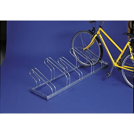 Metal bike rack with a yellow bike in it. On a blue background.