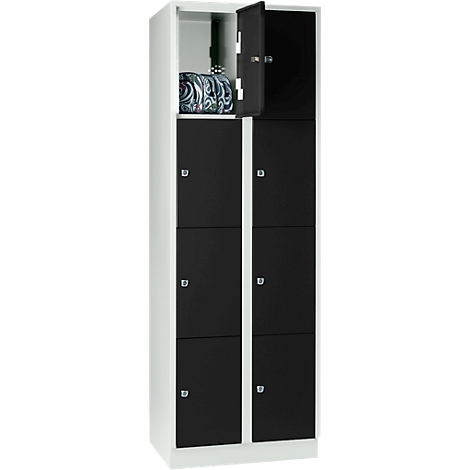 Cabinet with black doors, one door open, a bag inside.