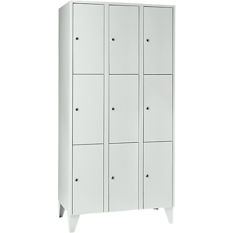White locker with nine compartments and small handles. It stands on narrow, white legs.