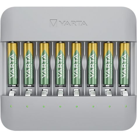 Grey charging station with seven inserted batteries. The batteries have green and gold colors, the charging station shows green lights.