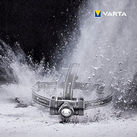 Varta headlamp surrounded by a white dust explosion. Details of the lamp can be seen.