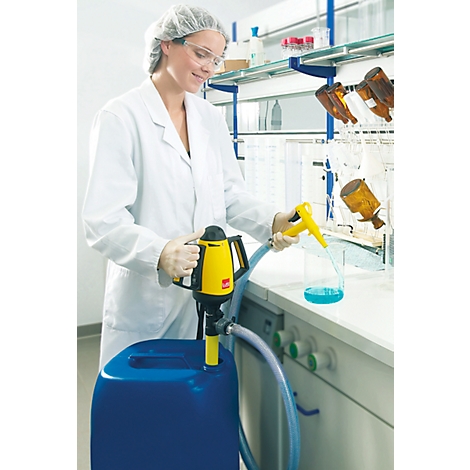 A woman in a lab coat is filling a blue canister with a yellow pump. She is wearing gloves and safety glasses.