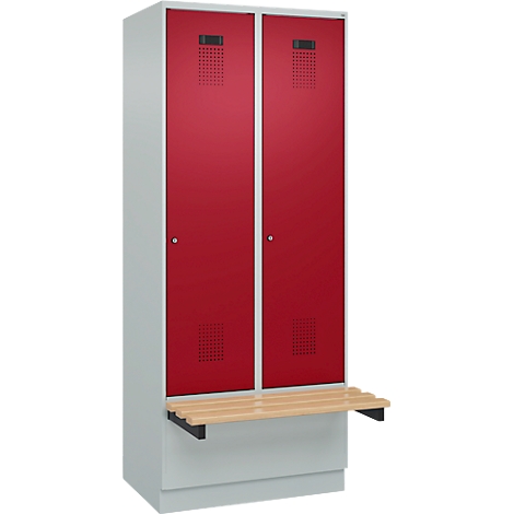 Casier avec deux portes rouges, des évents perforés et un banc en bois.