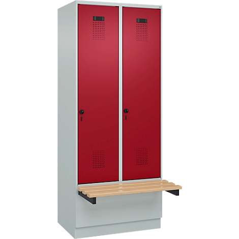 Casier avec deux portes rouges, fentes d'aération et banc en bois.