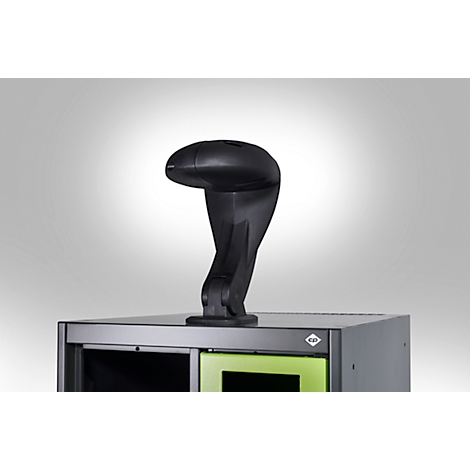 Scanner noir en forme de cobra, posé sur une armoire grise, sur fond blanc.
