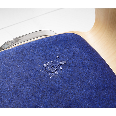 Close-up of a blue chair with water stains. The chair has a wooden back and a metal bar.