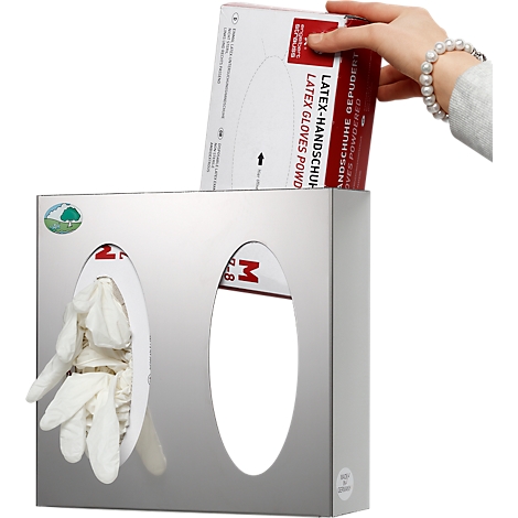 Hand placing latex gloves into dispenser. Dispenser is metal with two openings. One contains gloves.