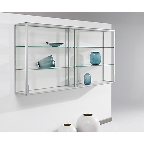 Hanging glass display cabinet with blue decorations, on a wall, with white vases.