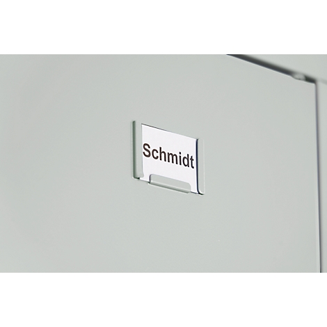 Name tag "Schmidt" in holder on cabinet door.