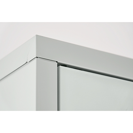Close-up of a grey cabinet corner. Edges are cleanly finished, surfaces smooth.
