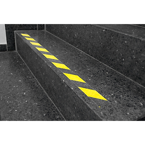 Stair steps with black and yellow markings. Yellow diamond pattern on the front of the steps.