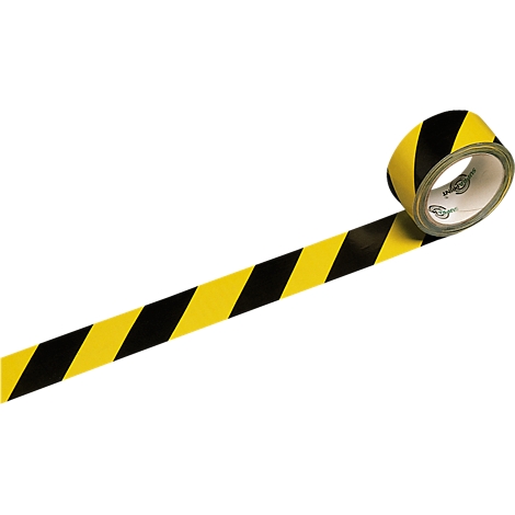 Yellow and black hazard tape unrolling from a roll.