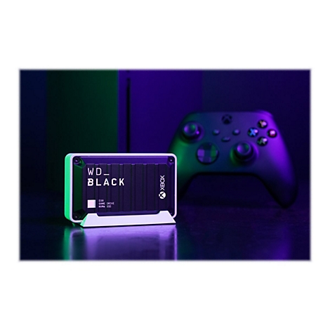 Festplatte mit WD_Black Schriftzug, daneben ein Controller. Neonfarben dominieren das Bild.