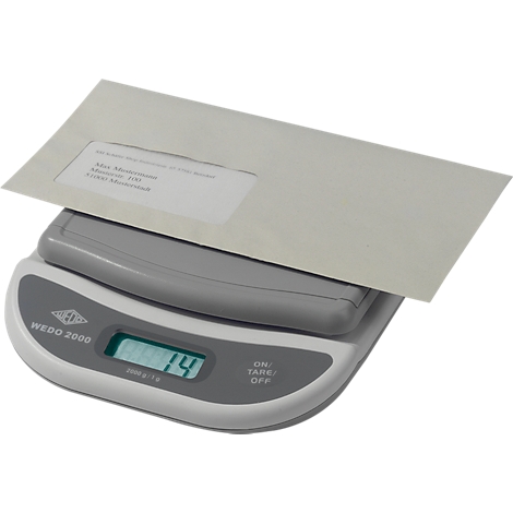 An envelope on a postal scale. The display shows 14.