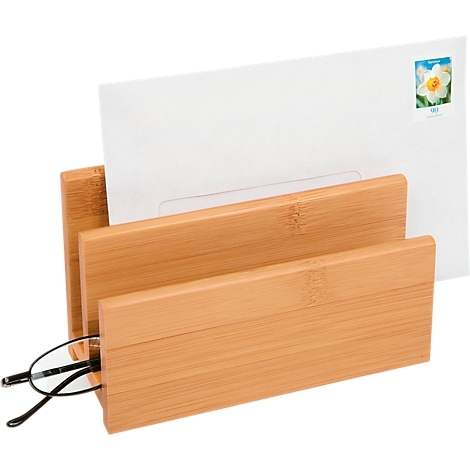Bamboo letter tray with two compartments. A white letter with a stamp is in one compartment, and glasses in the other.