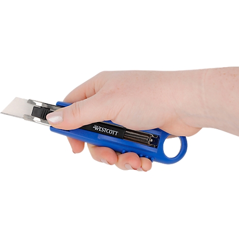 Hand holding a blue utility knife. The inscription "WESTCOTT" is visible.
