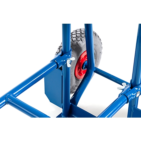 Close-up of a blue hand truck. The wheel has a red hub and a gray tire.