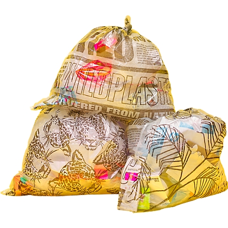 Three translucent plastic bags, printed with leopard heads, leaves, and text, filled with colorful waste.