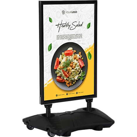 Bord met "Healthy Salad"-reclame, zwart frame, gele achtergrond, groen bladontwerp.