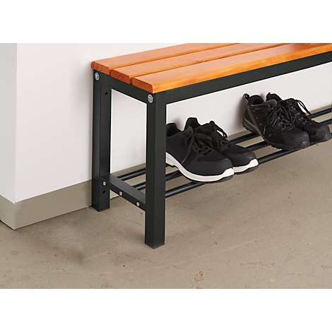 A shoe bench with a wooden top and black metal frame. Black shoes are on the shelves.