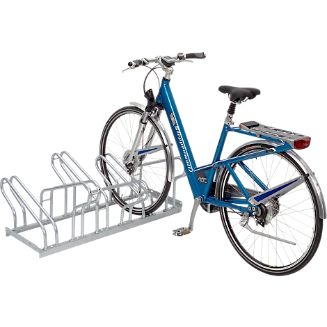 Blue bicycle in a bike rack. Rear wheel with luggage carrier. Silver stand, wheels, spokes.