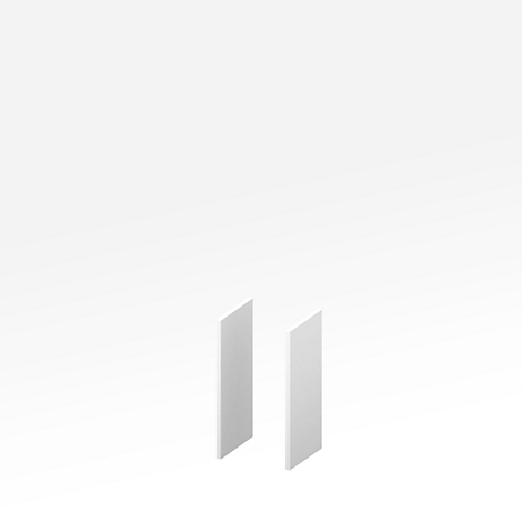 Two vertical, light rectangles stand on a white surface.