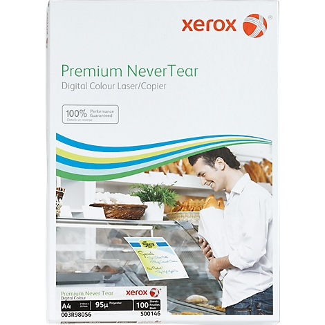 Man in bakery holding paper. The product says 'Premium Never Tear'.