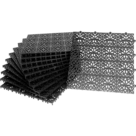 Black, plastic-like floor tiles. Individual tiles with geometric patterns, partially stacked, others lie beside.