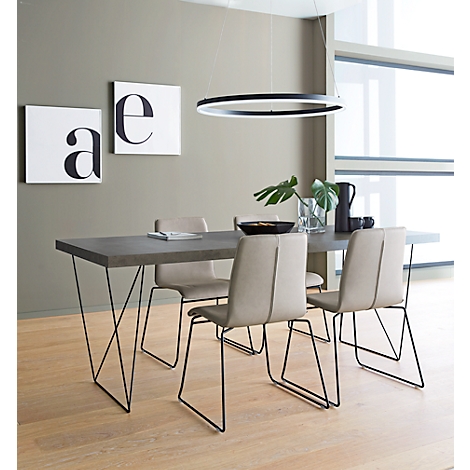 Dining room table with four chairs, pendant lamp. Two boards with the letters "a" and "e" are on the wall.