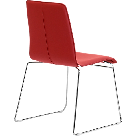 Red chair with metal legs. The backrest is rounded.