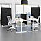 Bureau avec bureaux, chaises, cloisons noires et une façade vitrée avec vue sur la ville.