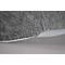 Gray felt fabric meets a light, wave-shaped plastic surface. The contrast of texture and shape is evident.