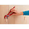 Person is using a red pliers to attach a fixing element on wood. The arm is dressed in a blue sweater.