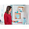 Woman in red shirt holding egg carton. Kitchen shelves with decor and utensils. Light blue water jug.