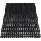Alfombra rectangular negra con agujeros en forma de panal.