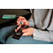 A person inserts a battery into a remote control. Another battery is held.