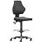 Black office chair with high back, seat and footrest. The chair has castors and a height-adjustable gas spring.