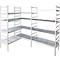 A multi-part, white corner shelf with multiple shelves. The shelves are perforated.