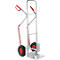 Hand truck with silver frame, red handles and wheels. An aid for transporting goods.
