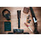 Hunting gear on wood: rifle, ammunition, knife, flashlight, hearing protection, notebook.