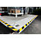 Loading ramp with trolley and boxes. Yellow and black markings on the edge.