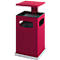 Red, square trash can with a lid. The trash can has side openings and stands on a light-colored base.