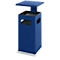 Blue painted trash can with removable lid, standing on a concrete base.