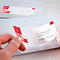 A hand removes an address label from a white envelope. The label is white with a red pattern and address data.