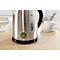 A stainless steel kettle sits on a table. Sticker "Next Inspection". A cup of tea next to it.