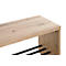 Gros plan sur un range-chaussures en bois. Le dessus est brun clair, les supports sont noirs.