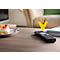 Remote control and batteries on a table. A piece of cake is next to it. Yellow arrow pointing to batteries.