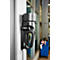Black cleaning device mounted on a wall installed in a workshop.